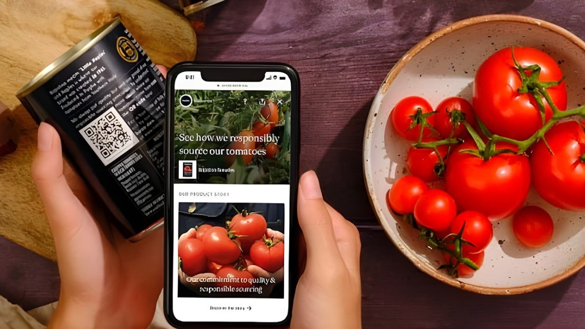 Hand holding food can with QR code next to smartphone showing tomato details