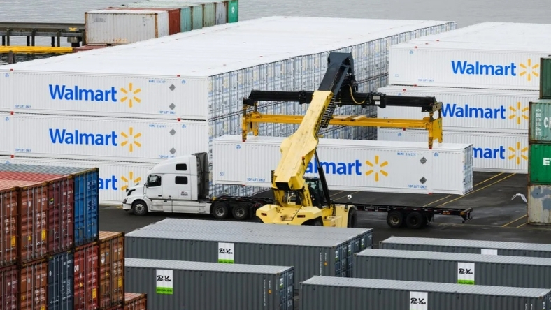 Container handling equipment loading Walmart shipping containers at a distribution port